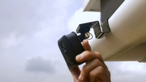 Camera held on a wall with an adhesive mount and no drilling