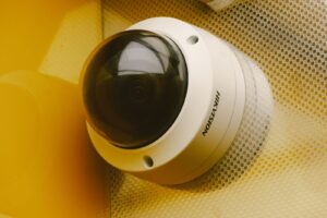 A modern indoor security camera mounted in a bright and peaceful living room.