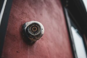 A modern magnetic wireless security camera mounted on the corner of a contemporary home.