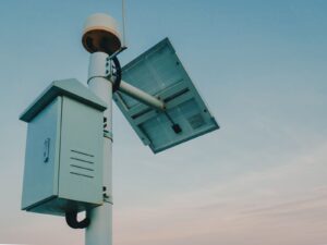 A modern solar-powered outdoor security camera mounted on a contemporary home exterior wall.