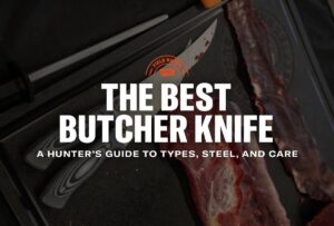 A sharp chef knife and raw steak on a butcher block for meat preparation.